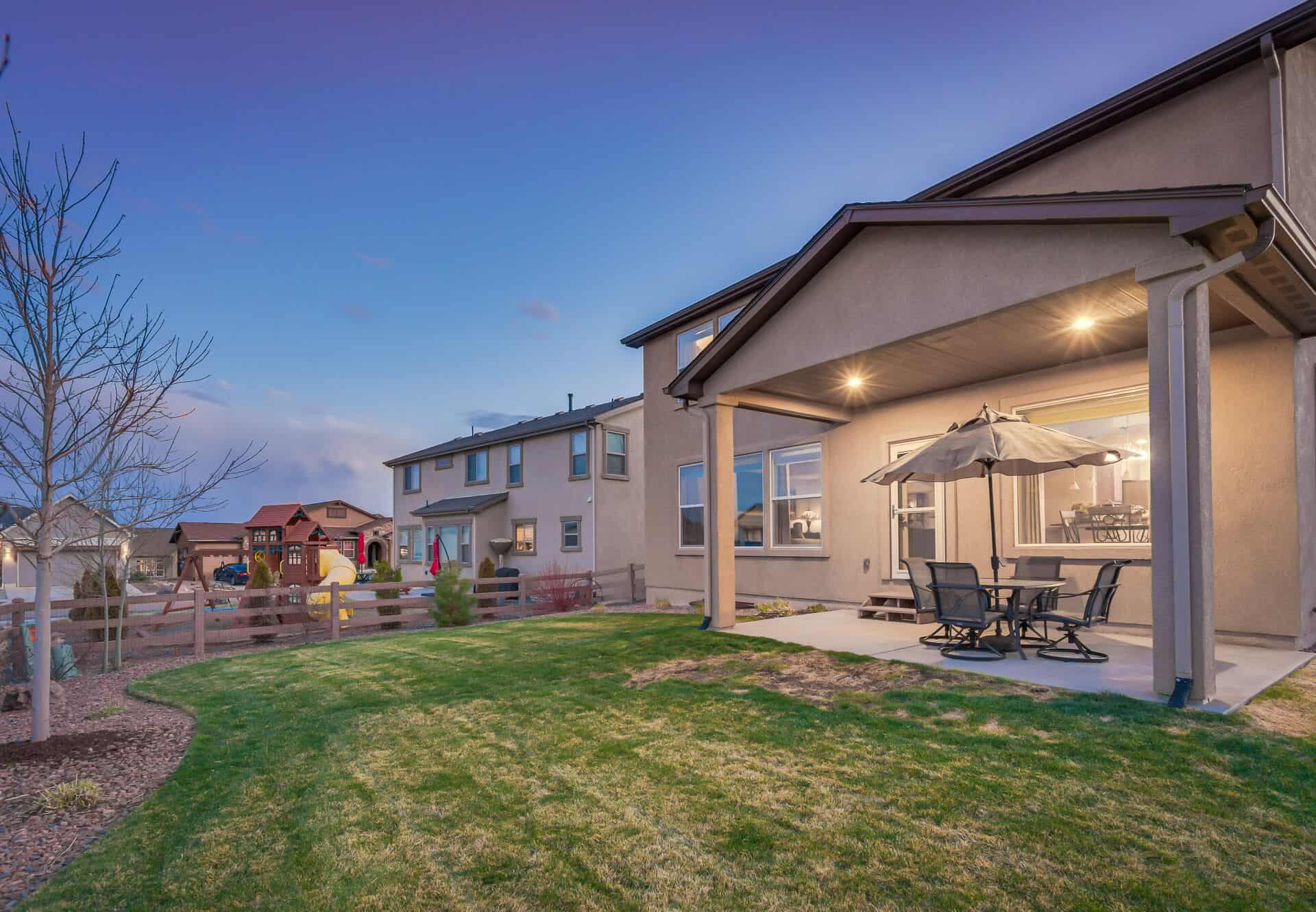Sunset View of Backyard with Covered Patio
